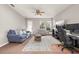 Comfortable living room with a ceiling fan, lots of space, and a view to the yard through the windows at 6821 Cultivation Way, Winter Garden, FL 34787