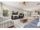 Spacious living room with natural light, ceiling fan, and an open floor plan flowing into the dining area at 6821 Cultivation Way, Winter Garden, FL 34787