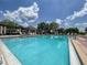 Resort style community pool with plenty of seating and shade umbrellas at 6821 Cultivation Way, Winter Garden, FL 34787