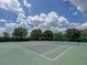 Well maintained community tennis courts under a sunny sky with fluffy clouds at 6821 Cultivation Way, Winter Garden, FL 34787