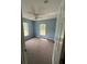 Bedroom featuring soft blue walls, carpeting, and two windows providing natural light at 7431 Cr 629, Bushnell, FL 33513