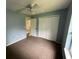 Cozy bedroom with blue walls, a ceiling fan, and a closet at 7431 Cr 629, Bushnell, FL 33513
