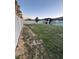 A large backyard is enclosed by a white vinyl fence and features a covered patio at 748 Citrus Isle Dr, Davenport, FL 33837