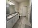 Clean bathroom with a double sink vanity and tiled flooring at 748 Citrus Isle Dr, Davenport, FL 33837