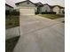 Attractive home with a well-manicured lawn, a spacious driveway, and a two-car garage at 748 Citrus Isle Dr, Davenport, FL 33837