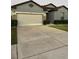 Charming home exterior with well-maintained lawn, landscaping, and a two-car garage at 748 Citrus Isle Dr, Davenport, FL 33837