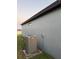 A grey house exterior is shown with a Lennox air conditioning unit sitting on a concrete pad at 748 Citrus Isle Dr, Davenport, FL 33837
