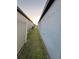 The exterior of the house sits beside the backyard area with grass and a white vinyl fence at 748 Citrus Isle Dr, Davenport, FL 33837