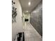 Bright hallway featuring modern, decorative stone-style wall and tile flooring at 748 Citrus Isle Dr, Davenport, FL 33837