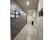 Inviting hallway with a decorative stone accent wall and neutral tile flooring at 748 Citrus Isle Dr, Davenport, FL 33837