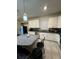 Well-lit kitchen featuring white cabinets, granite countertops, and a central island with bar seating at 748 Citrus Isle Dr, Davenport, FL 33837