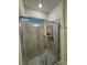 Modern tiled shower stall with glass door and overhead lighting at 748 Citrus Isle Dr, Davenport, FL 33837