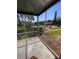 Screened in lanai with tile flooring and views of the community pool and green spaces at 781 W Lancaster Rd # B38, Orlando, FL 32809