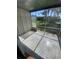 Enclosed lanai with tiled floor offering views of community pool and greenspace at 781 W Lancaster Rd # B38, Orlando, FL 32809