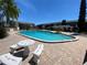 A beautiful swimming pool with an adjacent table and benches for relaxing poolside at 781 W Lancaster Rd # B38, Orlando, FL 32809