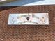 Close-up of the 'Ambassador House Condominium' sign on a brick wall at 781 W Lancaster Rd # B38, Orlando, FL 32809