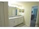 Bathroom featuring a double vanity sink, granite countertops and flooring at 9042 Stinger Dr, Davenport, FL 33896