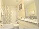 Bathroom with a shower/tub combo and a granite sink vanity at 9042 Stinger Dr, Davenport, FL 33896