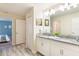 Well-lit bathroom with double sinks, granite countertops, and modern fixtures at 9042 Stinger Dr, Davenport, FL 33896