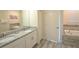 Bathroom with double sinks, granite counters, tub and tile flooring at 9042 Stinger Dr, Davenport, FL 33896