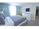 Bright bedroom with a bed, modern dresser, and bright natural light for a welcoming feel at 9042 Stinger Dr, Davenport, FL 33896