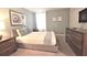 Cozy bedroom features carpet, a bed, dresser, and a window for natural light at 9042 Stinger Dr, Davenport, FL 33896