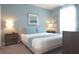 Inviting bedroom with a bed, bedside table, and soft, natural light from the window at 9042 Stinger Dr, Davenport, FL 33896