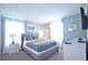 Serene bedroom with a bed, bedside table, and bright, natural light for a peaceful retreat at 9042 Stinger Dr, Davenport, FL 33896