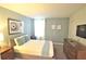 Comfortable bedroom features carpet, a bed, dresser, and a window for natural light at 9042 Stinger Dr, Davenport, FL 33896