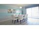 Stylish dining room featuring a modern table, white chairs, and a view of the outdoors at 9042 Stinger Dr, Davenport, FL 33896