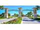Grand entrance to the community with manicured landscaping at 9042 Stinger Dr, Davenport, FL 33896