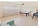 Spacious garage setup with a pool table and laundry area at 9042 Stinger Dr, Davenport, FL 33896