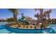 Community pool featuring a waterslide and tropical landscaping for a resort-like experience at 9042 Stinger Dr, Davenport, FL 33896