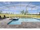 Screened-in pool with lounge chairs and manicured lawn at 9042 Stinger Dr, Davenport, FL 33896