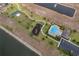 Aerial shot featuring a community with a lake, playground, tennis court, and pool at 9056 Wildflower Ln, Kissimmee, FL 34747