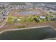 Aerial shot featuring a community with a lake, playground, tennis court, and pool at 9056 Wildflower Ln, Kissimmee, FL 34747