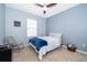Cozy bedroom features a comfortable bed, stylish chair, and a ceiling fan at 9056 Wildflower Ln, Kissimmee, FL 34747