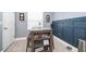 Dining nook with blue wainscoting, wooden table, and tiled floors at 9056 Wildflower Ln, Kissimmee, FL 34747