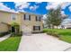 Charming two-story home with a well-maintained lawn, lush landscaping, and a convenient attached garage at 9056 Wildflower Ln, Kissimmee, FL 34747