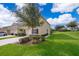 A manicured lawn and tidy landscaping surround this home with an attached garage at 9056 Wildflower Ln, Kissimmee, FL 34747