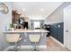 Kitchen features white countertop breakfast bar with two bar stools at 9056 Wildflower Ln, Kissimmee, FL 34747