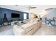 Spacious living area featuring a stylish accent wall, large sectional sofa, and modern furnishings at 9056 Wildflower Ln, Kissimmee, FL 34747
