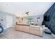 Bright living area with tile floors, comfortable sectional sofa, adjacent dining area and backyard access at 9056 Wildflower Ln, Kissimmee, FL 34747