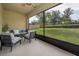 Relaxing screened-in patio, perfect for enjoying the outdoors with comfortable seating and serene backyard views at 9056 Wildflower Ln, Kissimmee, FL 34747