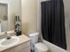 Neutral bathroom featuring a tub, shower with curtain and single sink vanity at 914 Caribbean Dr, Davenport, FL 33897