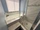 Bathroom featuring a shower with glass door and jacuzzi tub with tile surround at 914 Caribbean Dr, Davenport, FL 33897