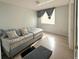 Comfortable bedroom with a large daybed, hardwood floors, and a sunlit window at 914 Caribbean Dr, Davenport, FL 33897