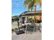 Outdoor patio with umbrella, table, chairs and manicured landscaping at 914 Caribbean Dr, Davenport, FL 33897