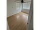 Bedroom with wood floors, ceiling fan, and a window for natural light at 924 Ferndell Rd, Orlando, FL 32808