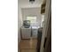 Functional laundry room with modern washer, dryer, water heater, and a window at 924 Ferndell Rd, Orlando, FL 32808